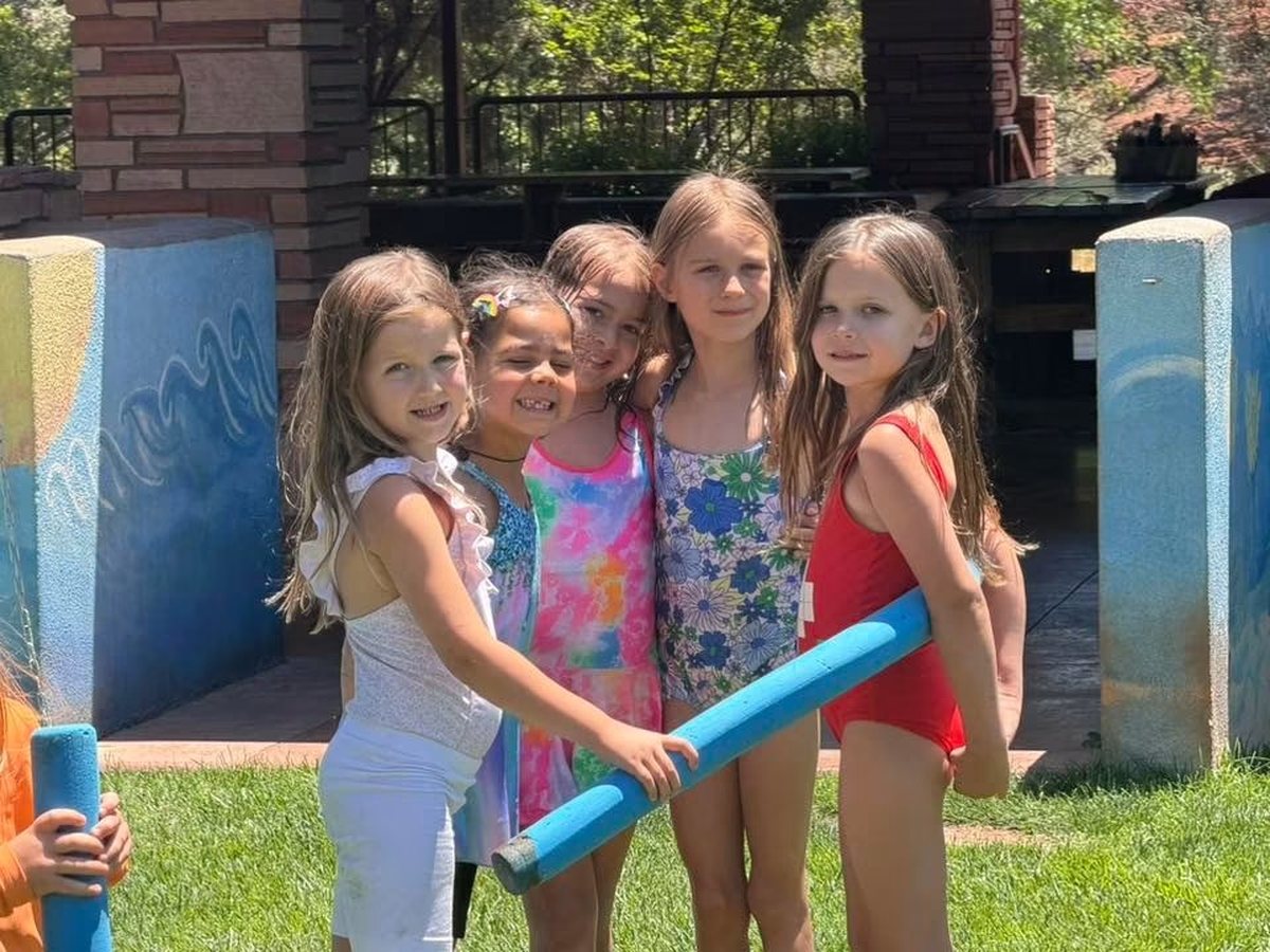 Campers playing water games on the lawn